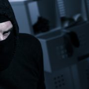 Masked burglar with flashlight