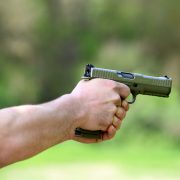 Soldier taking aim with an automatic pistol