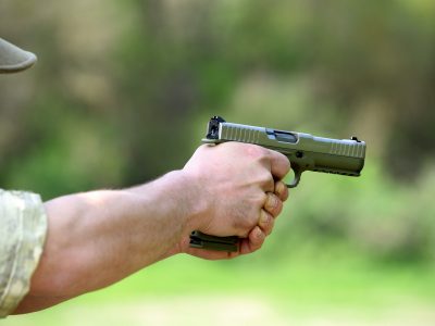 Soldier taking aim with an automatic pistol