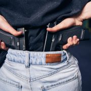 Female carrying with two handguns hidden in her jeans pants