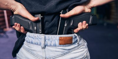 Female carrying with two handguns hidden in her jeans pants