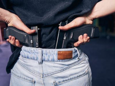 Female carrying with two handguns hidden in her jeans pants