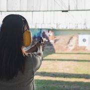 Young woman practice gun shoot on target