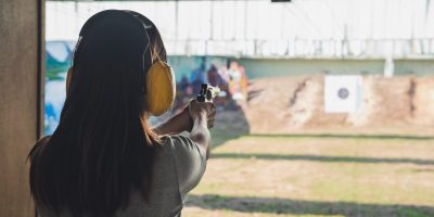 Young woman practice gun shoot on target