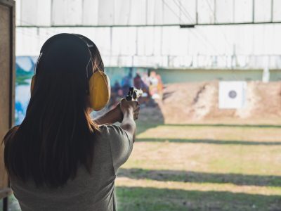 Young woman practice gun shoot on target